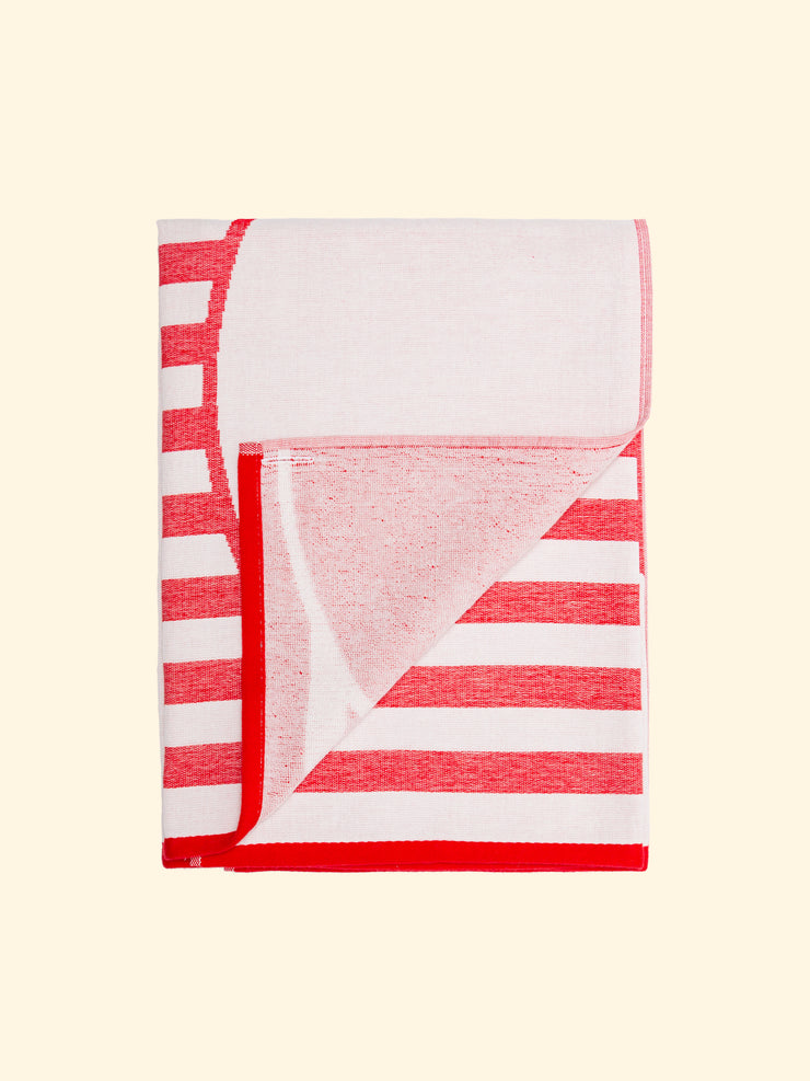 Model “Crassa” of Tucca light beach towel, 100% organic cotton, folded while the top side is completely flat and fresh and the underside one woven with terry. All woven, not printed, for optimal drying and preservation of color